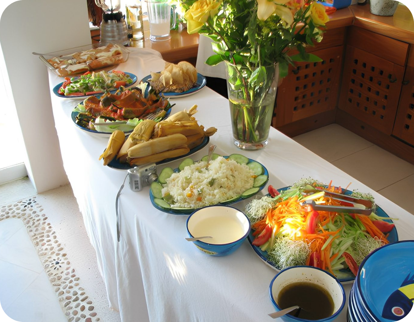 Buffet table with a variety of salads, vegetables, and sauces.