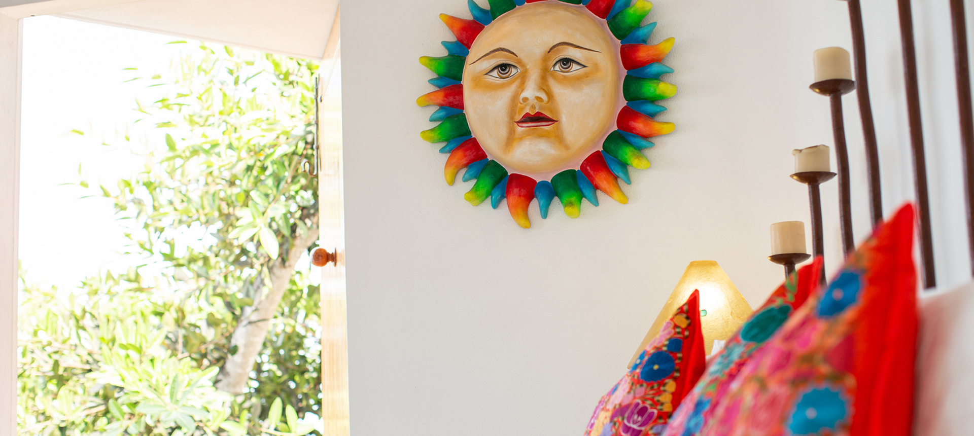 Sun decoration above colorful pillows